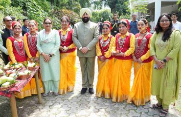 Women in traditional attire performing auspicious songs of Harela with the Governor on the occasion of Harela festival.