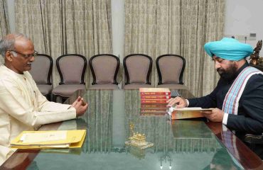 Prof. Dinesh Chandra Shastri meeting the Governor and presenting books based on Mimamsa philosophy.