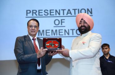 Officials presenting a memento to the Governor at a function