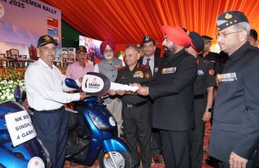 The Governor distributing scooters to disabled veterans on behalf of the War Wounded Organization.