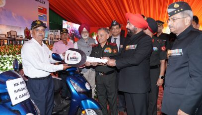 The Governor distributing scooters to disabled veterans on behalf of the War Wounded Organization.