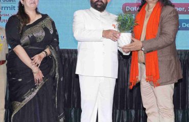 Senior journalist Mr. Satish Sharma presenting a plant to the Governor on the occasion of the programme.