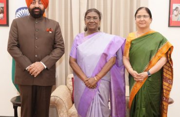 Governor presenting the book “Mountains of Labour; Currents of Change – Women's Livelihood and Economic Transitions in the Himalayan Region and Uttarakhand” to the President.