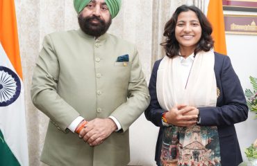 Governor honouring cricketer Sneh Rana by presenting her a shawl.