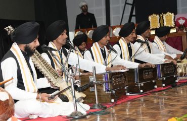 The Governor listening to the performances given by the children in the program 