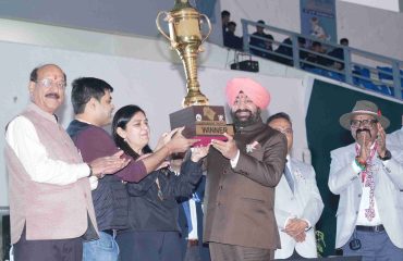 Governor presenting the trophy to the winning team