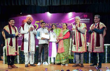 Governor presenting medals and degrees to students