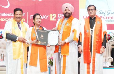 The Governor presenting a medal and degree to a student