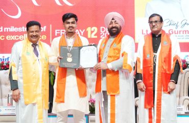 The Governor presenting a medal and degree to a student.