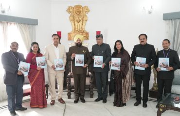 Dr. Ravi Dutt Godiyal, and other members of the commission presenting the 24th report of the commission to the Governor.