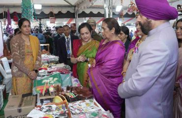 The Governor inspecting and gathering information from the stalls set up by self-help groups at the Uttarayani Kauthik Festival-2026 organized by Seva Sankalp Foundation.