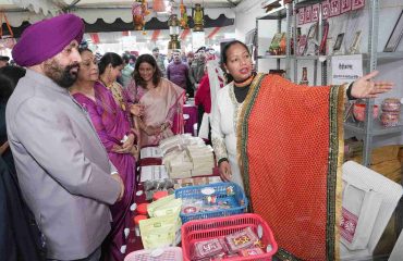 The Governor inspecting and gathering information from the stalls set up by self-help groups at the Uttarayani Kauthik Festival-2026 organized by Seva Sankalp Foundation.