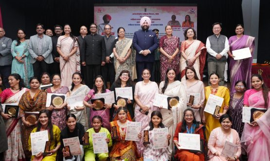 Governor with girls and women at the programme