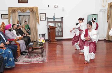 The Governor watching a cultural dance performance presented by young girls during a program organized to mark the State Foundation Days of Rajasthan and Odisha.