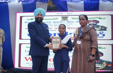 The Governor honoring a meritorious student with a certificate of appreciation at the Government Senior Secondary School, Jalal Usman, Amritsar.