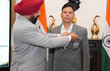 The Governor presenting badges to security personnel at Lok Bhavan.