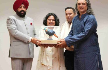 The Governor presenting mementos to the film's lead actor, Mr. Satish Sharma, director Mr. Raja Chatterjee, and producer Mrs. Sakshi Shail Chatterjee, at the special screening of the short film 'Misty'.