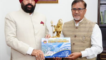 Vice-Chancellor Prof. Diwan S. Rawat presenting a coffee table book showcasing the university's achievements and innovations to the Governor.
