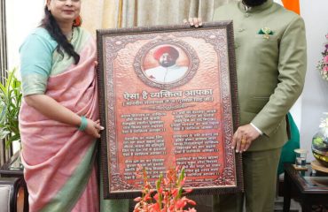 Poet and writer Naina Kanswal presenting her work to the Governor.