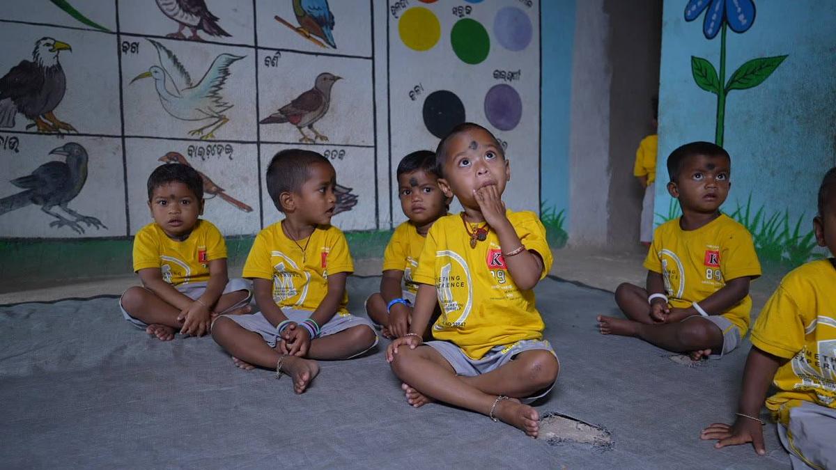 Children at an Anganwadi centre, looking up during an activity