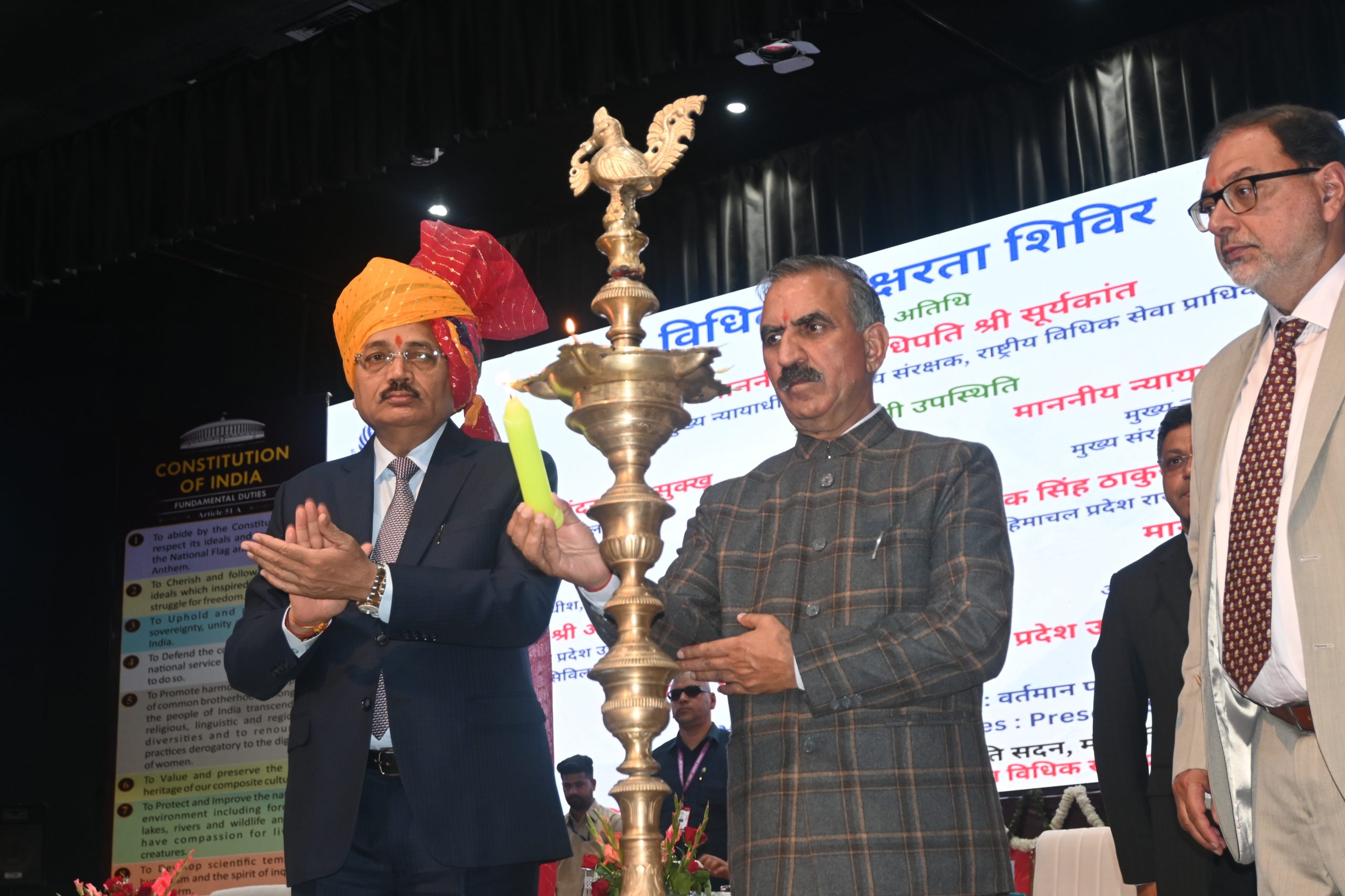 Lighting of the ceremonial lamp by the esteemed dignitaries.
