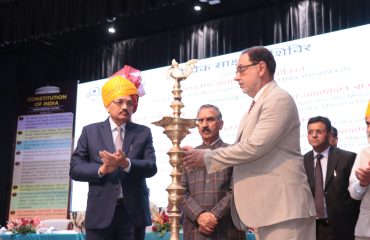 Lighting of the ceremonial lamp by the esteemed dignitaries.