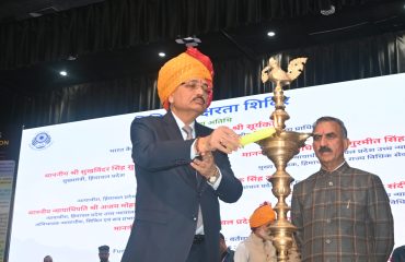 Lighting of the ceremonial lamp by the esteemed dignitaries.