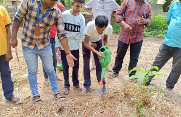 Students watering the gardening raised bed