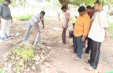 Students preparing pile compost with waste materials