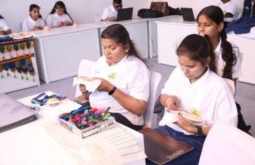 This picture shows a stall at Purple Fest 2025 where two divyang women are engaged in craftwork.