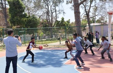 Divyang children are playing basketball in the Game Zone of Purple Fest 2025 at Rashtrapati Bhavan.