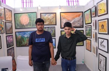 This picture shows a stall at Purple Fest 2025. Two children with intellectual disabilities are standing at the stall.