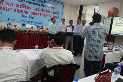 Principal is receiving trophy & certificate