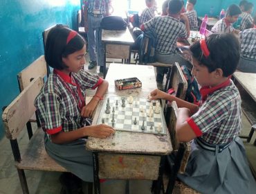 जूनियर कक्षा के छात्र शतरंज का अभ्यास करते हुए