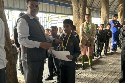 Children receiving certificates from principal