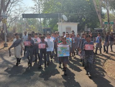 Rally under Jal Pakhwada 2026 marching outside near colony entrance