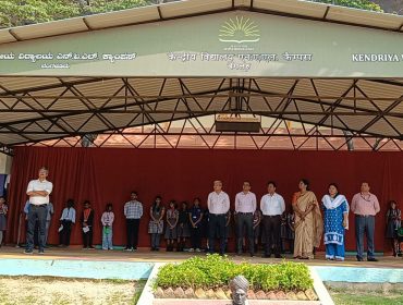 Assistant commissioner Hema K address the school assembly