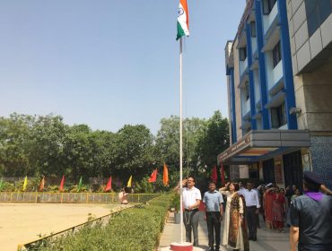 Image Showing: DC Sir and school staff saluting our National Flag
