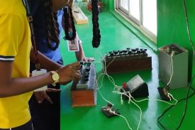 Students performing experiment in Physics lab