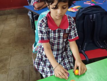 Class one student making clay toys