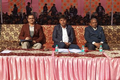 YOUTH PARLIAMENT FACULTY SITTING NEAR STAGE