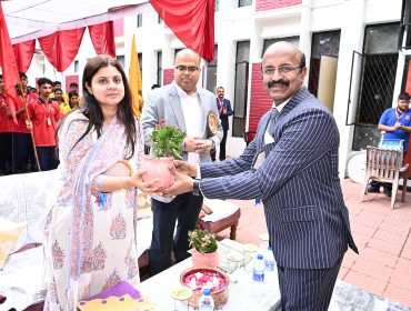 Principal Presenting Sapling to Guest of Honor